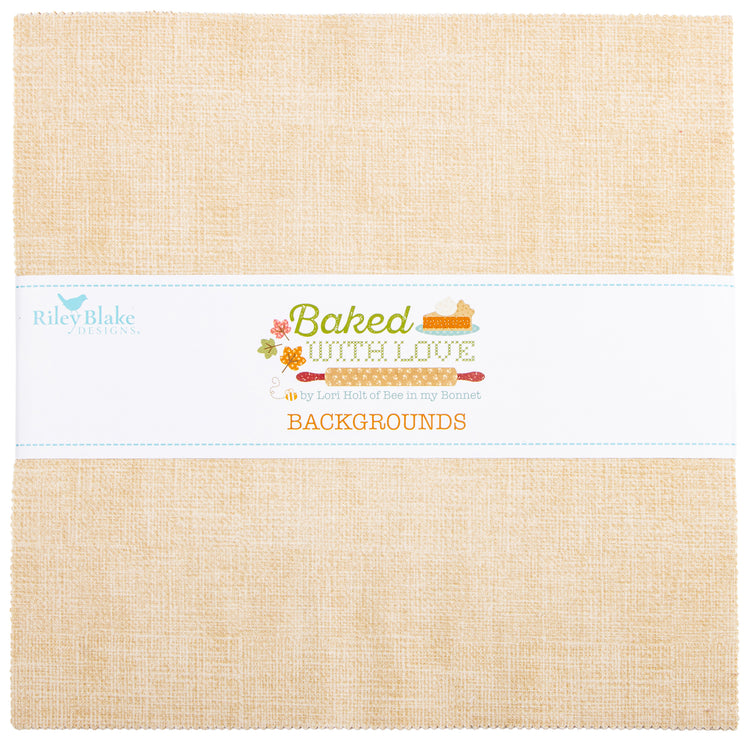 A square fabric or paper background product by Riley Blake Designs, shown folded with a white paper band across the middle. The material has a warm beige linen-like texture, and the band reads 'Baked with Love' and 'BACKGROUND' with small baking-themed illustrations.