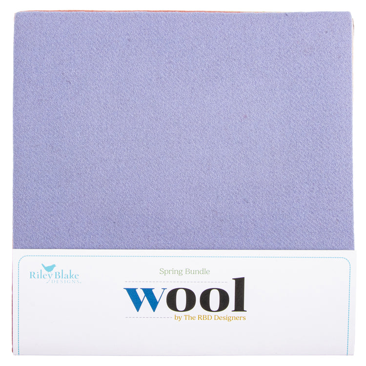 A square fabric labeled 'Spring Bundle Wool' by Riley Blake, showing a soft lavender-purple wool texture above a white printed label.