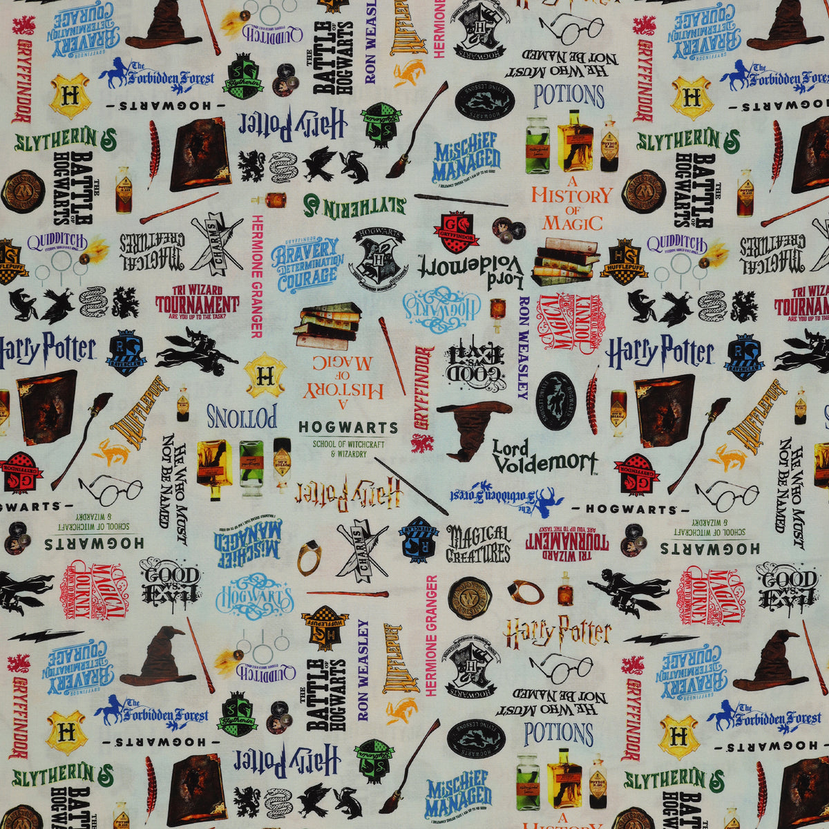 Pale blue Harry Potter fabric with multicolored words, house crests, books, potion bottles, wands and spectacles.