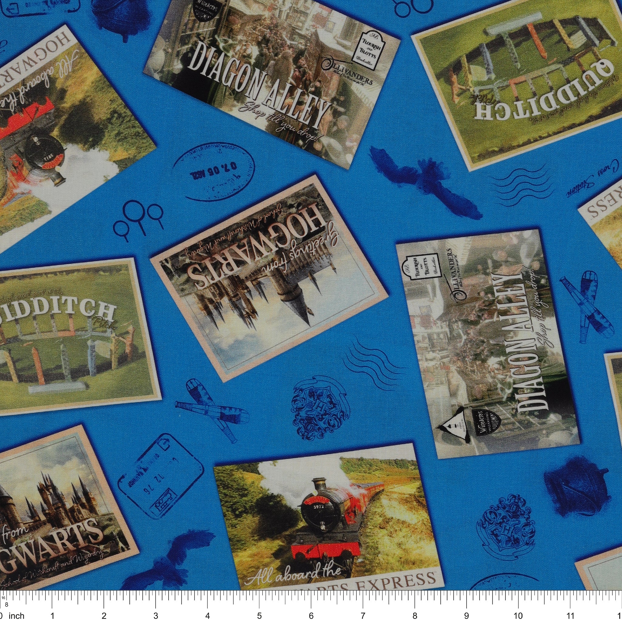 Royal-blue fabric with Hogwarts, Hogwarts Express, Diagon Alley and Quidditch postcards, plus postal marks with ruler for scale.