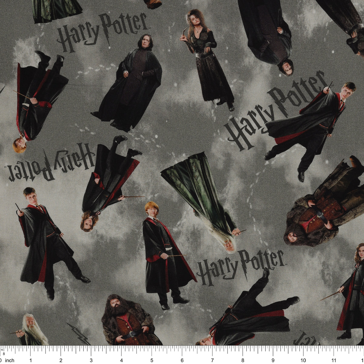Gray Harry Potter fabric with scattered robed film figures, black logos, lightning bolts and pale footprints with ruler for scale.