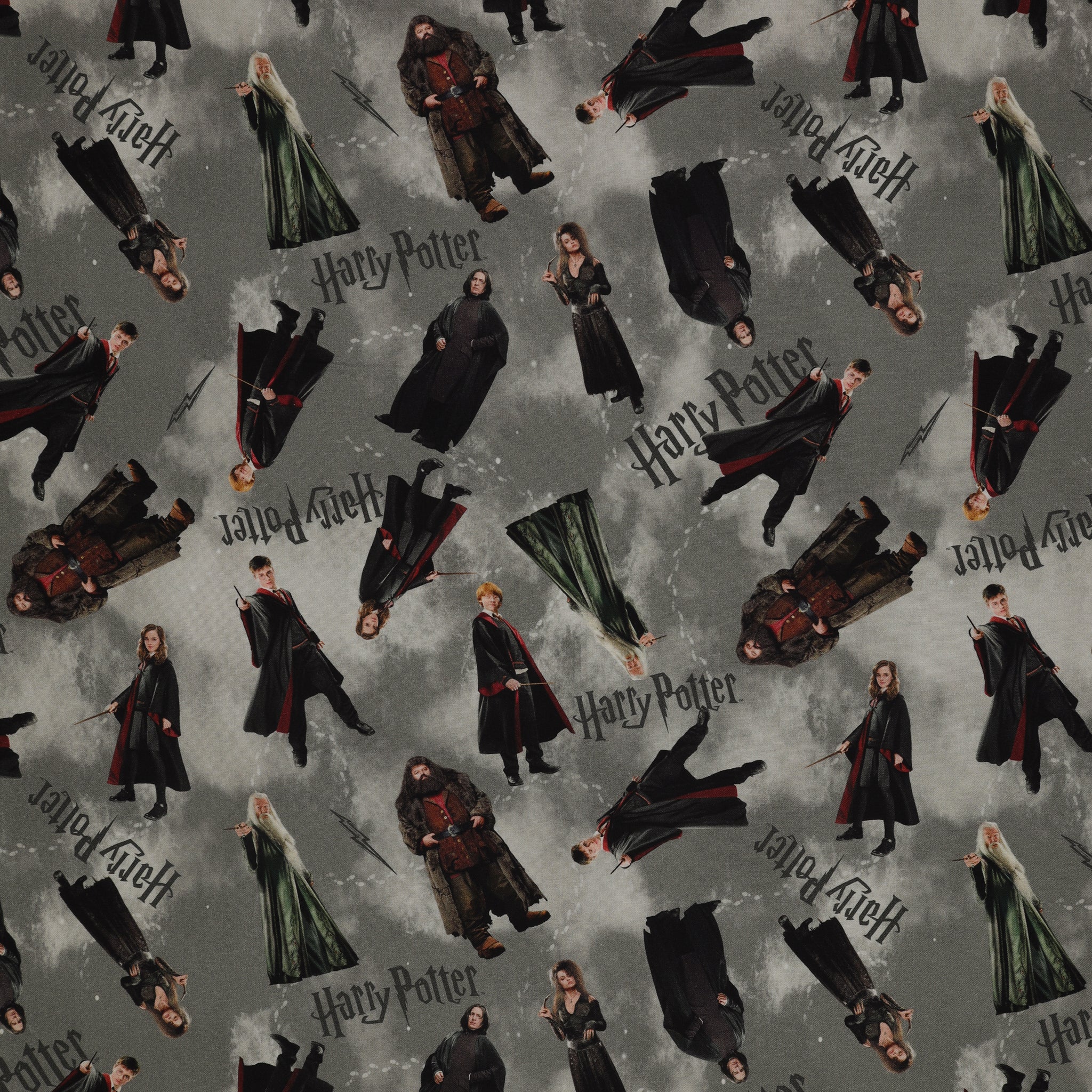 Gray Harry Potter fabric with scattered robed film figures, black logos, lightning bolts and pale footprints.