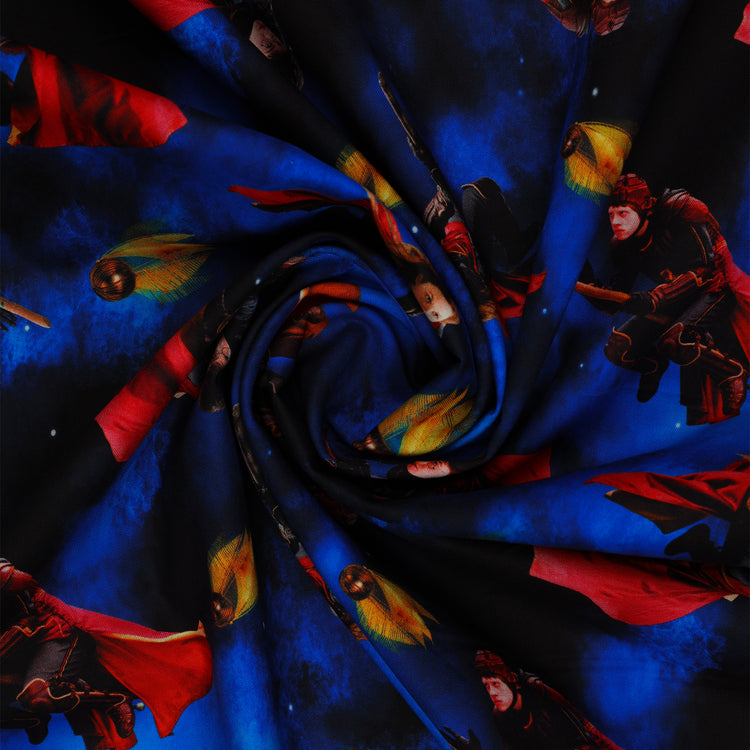 Red-caped broomstick riders and Golden Snitches on an electric-blue and black Harry Potter fabric background in a swirl.