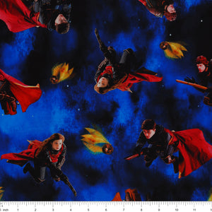 Red-caped broomstick riders and Golden Snitches on an electric-blue and black Harry Potter fabric background with ruler for scale.