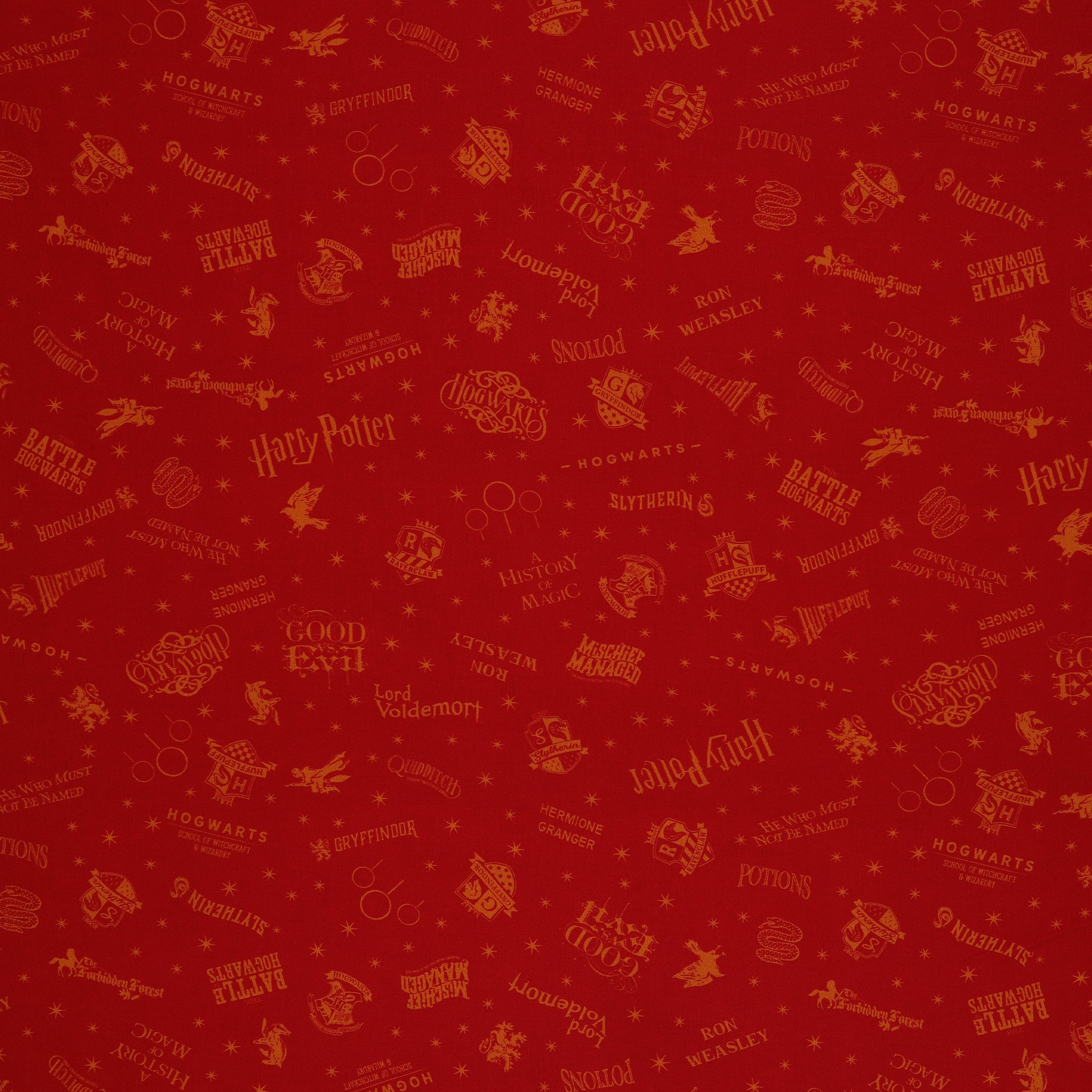 Red Harry Potter fabric with golden-yellow lettering, Hogwarts house shields and scattered stars.