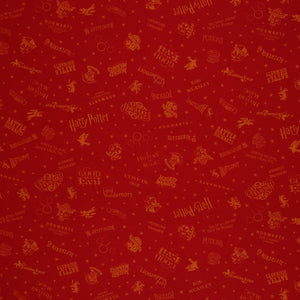 Red Harry Potter fabric with golden-yellow lettering, Hogwarts house shields and scattered stars.