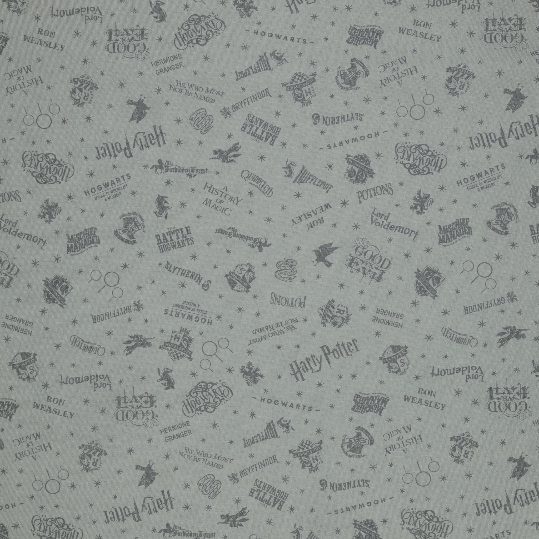 Light gray Harry Potter fabric with darker gray lettering, Hogwarts crests, magical icons and stars.