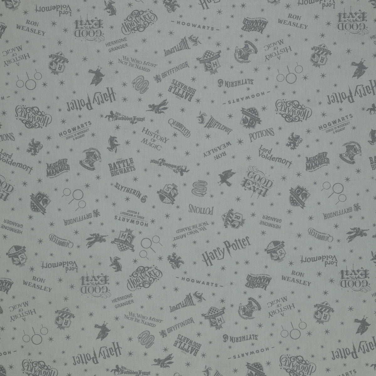 Light gray Harry Potter fabric with darker gray lettering, Hogwarts crests, magical icons and stars.