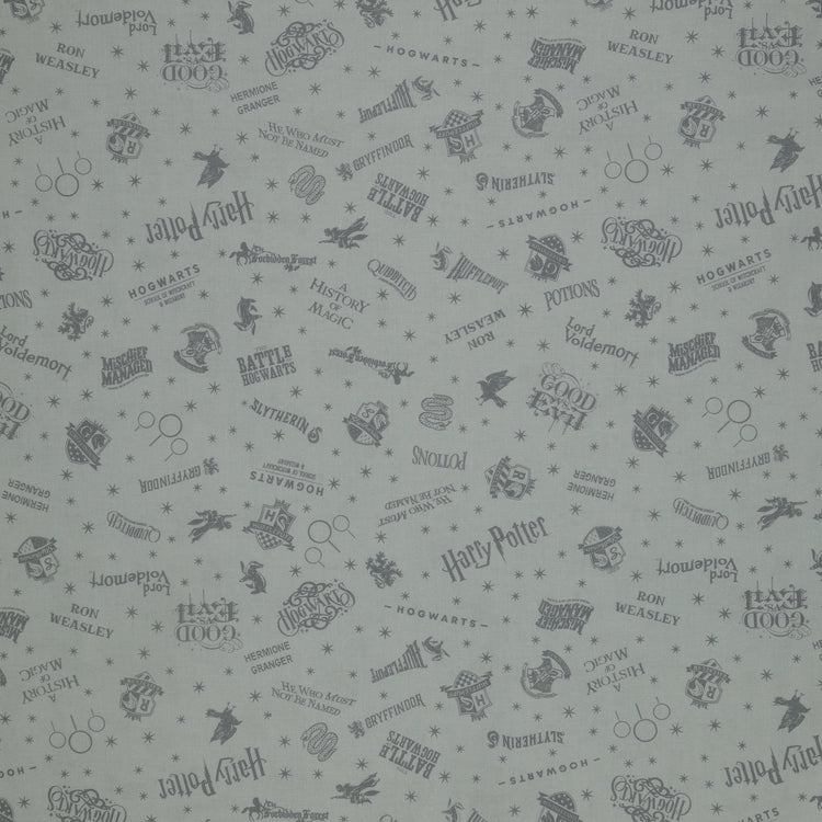 Light gray Harry Potter fabric with darker gray lettering, Hogwarts crests, magical icons and stars.