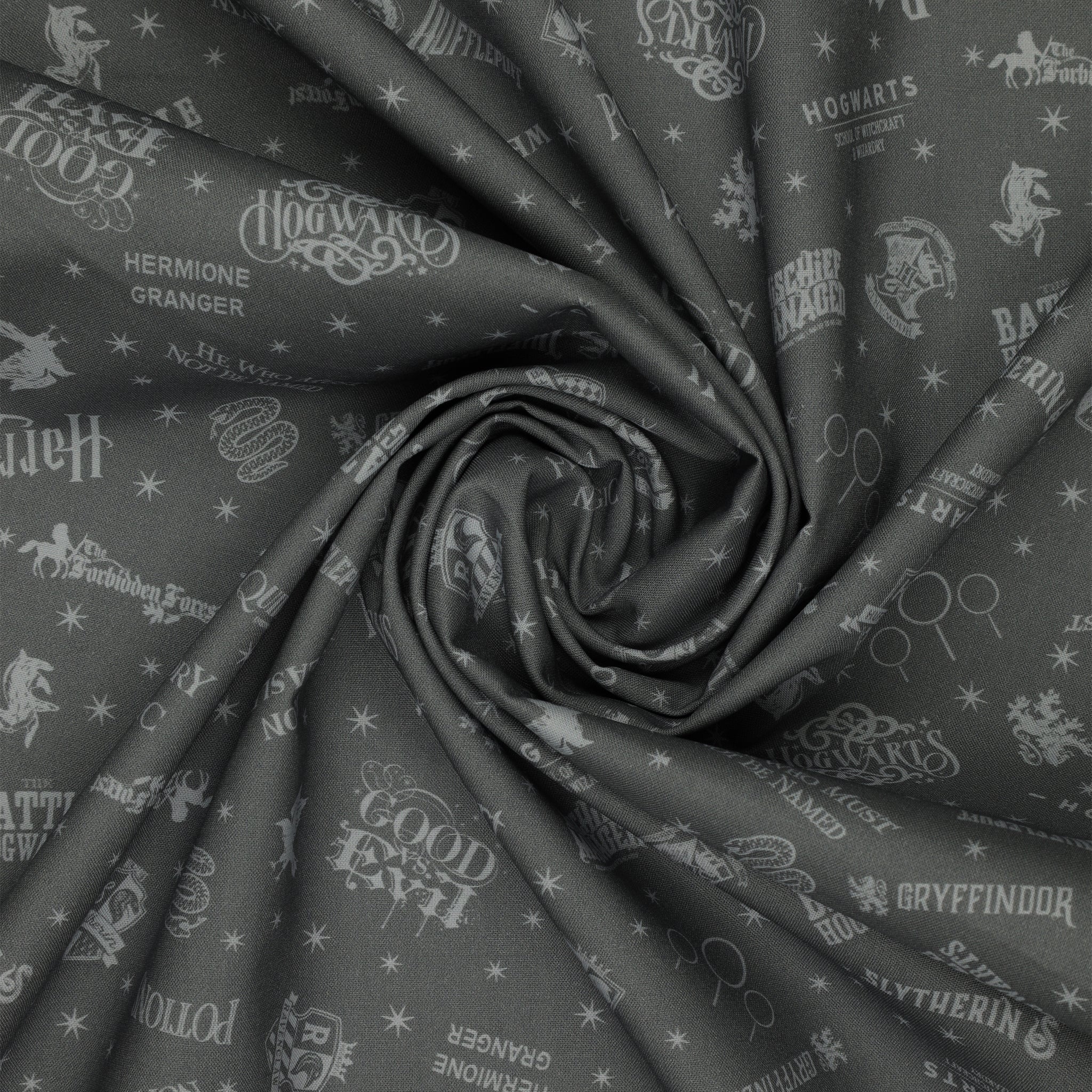 Charcoal Harry Potter fabric with pale gray words, house crests, Quidditch goalposts and stars in a swirl.
