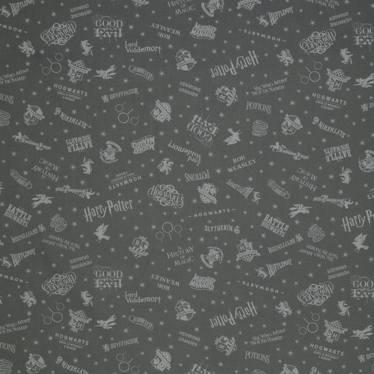 Charcoal Harry Potter fabric with pale gray words, house crests, Quidditch goalposts and stars.