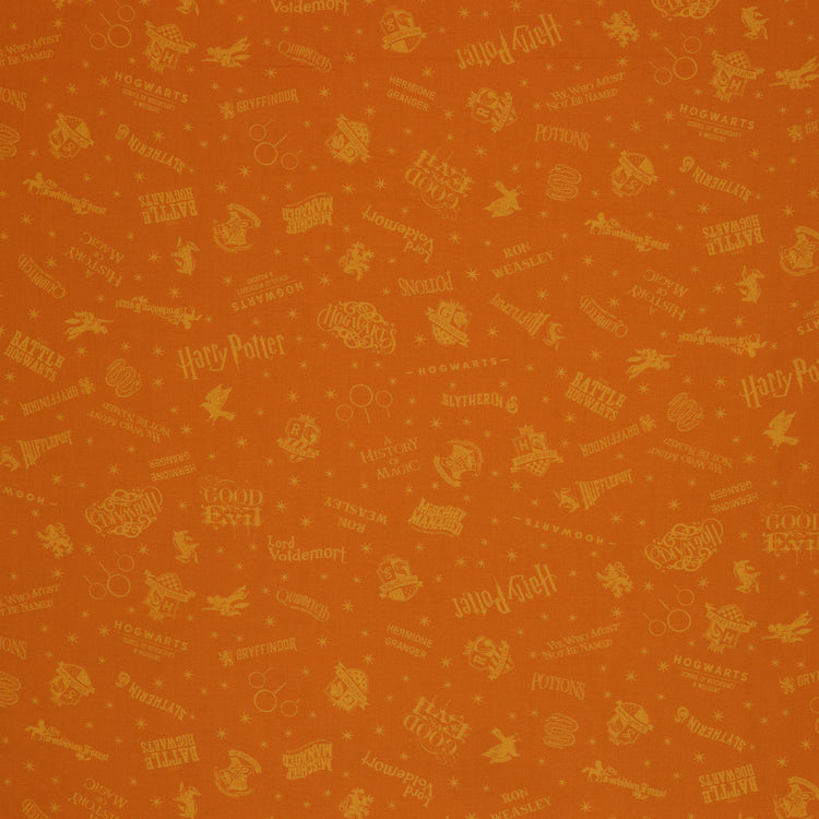 Amber-gold Harry Potter fabric with lighter golden words, house emblems and tiny starbursts.