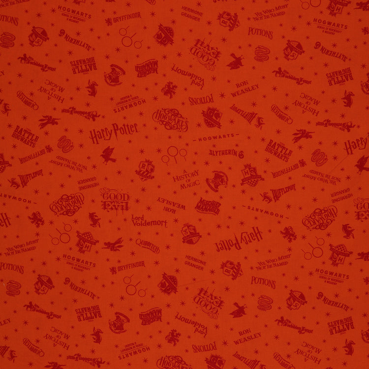 Orange Harry Potter fabric with rust-red words, Hogwarts house crests and scattered starbursts.