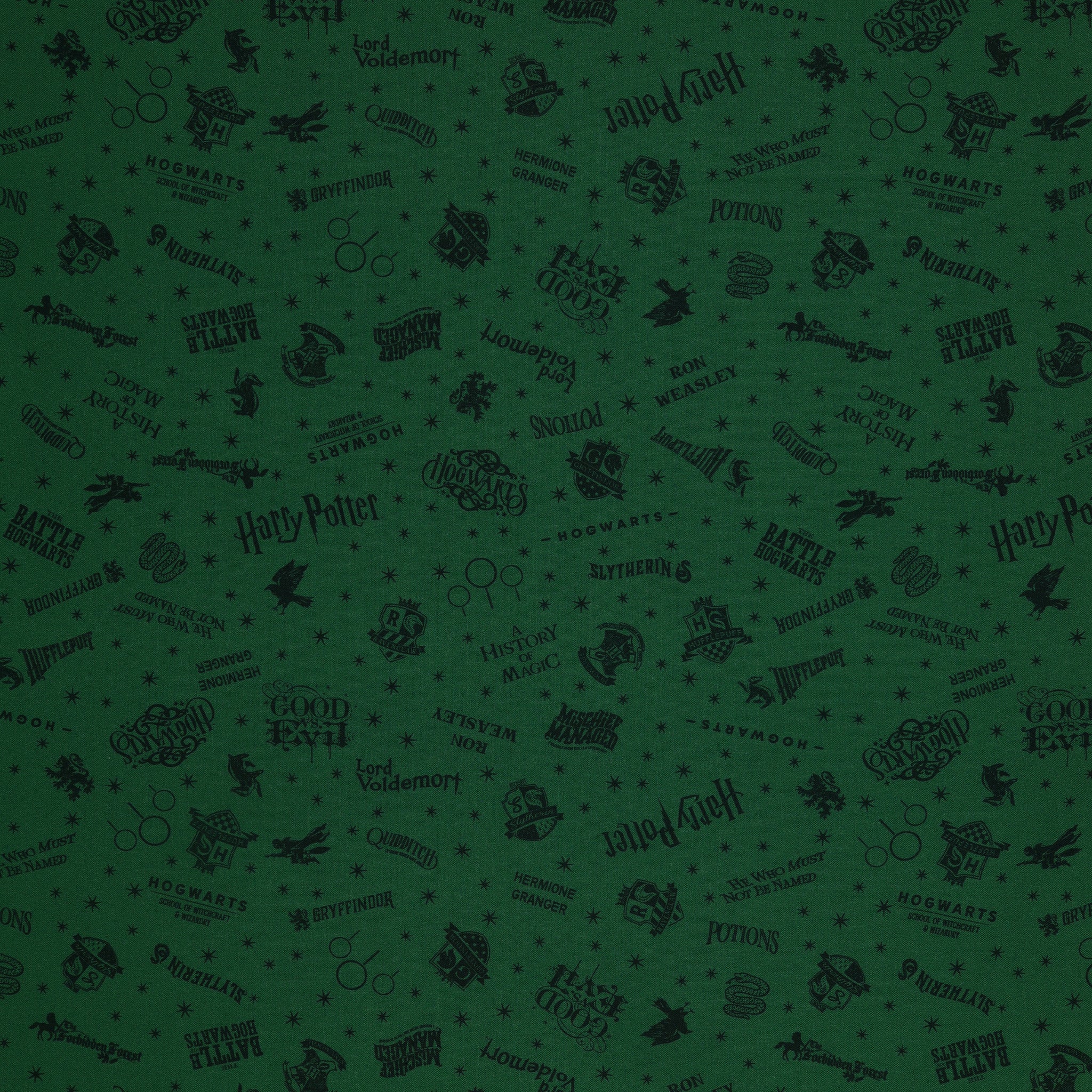 Dark green Harry Potter fabric with nearly black house crests, serpents, words and scattered stars.