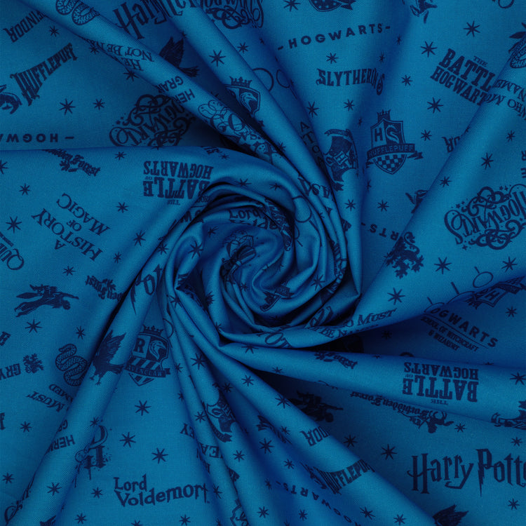 Blue Harry Potter fabric with navy lettering, house badges, Quidditch goalposts and small stars in a swirl.