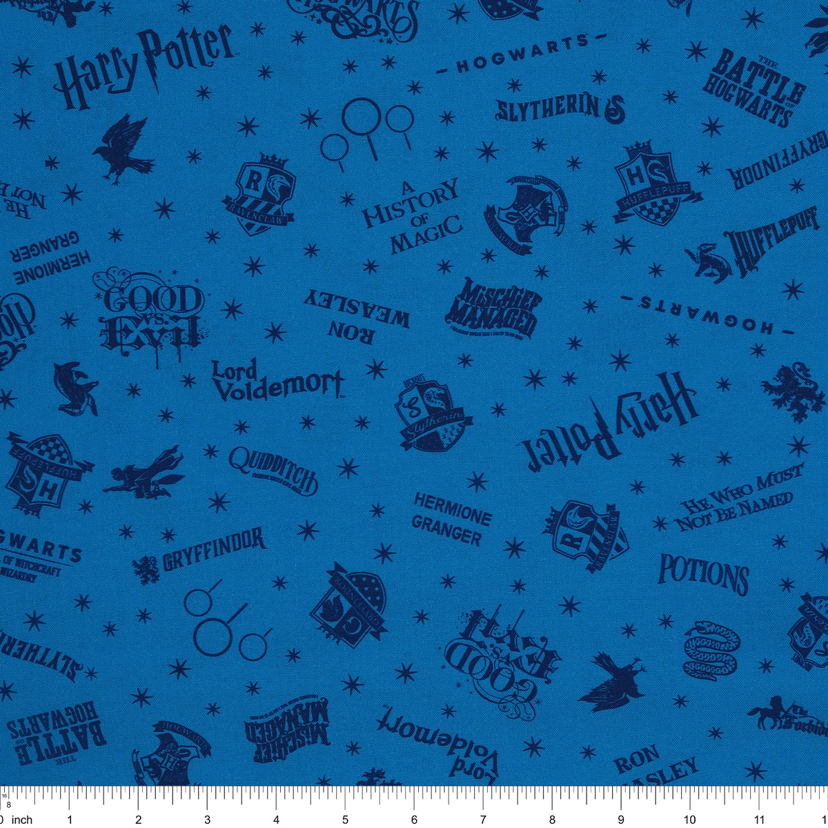 Blue Harry Potter fabric with navy lettering, house badges, Quidditch goalposts and small stars with ruler for scale.