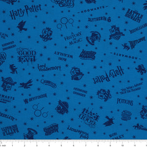 Blue Harry Potter fabric with navy lettering, house badges, Quidditch goalposts and small stars with ruler for scale.