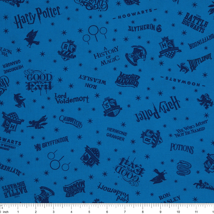 Blue Harry Potter fabric with navy lettering, house badges, Quidditch goalposts and small stars with ruler for scale.