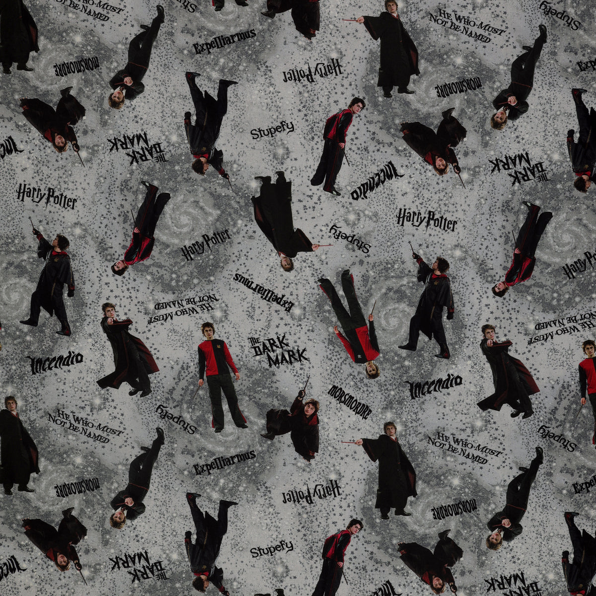 Gray Harry Potter fabric with wand-wielding figures, spell names, stars and smoky swirls.