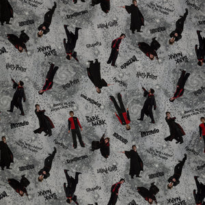 Gray Harry Potter fabric with wand-wielding figures, spell names, stars and smoky swirls.