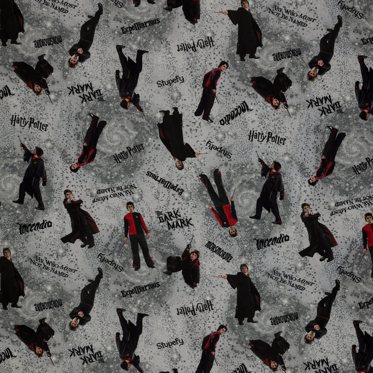 Gray Harry Potter fabric with wand-wielding figures, spell names, stars and smoky swirls.