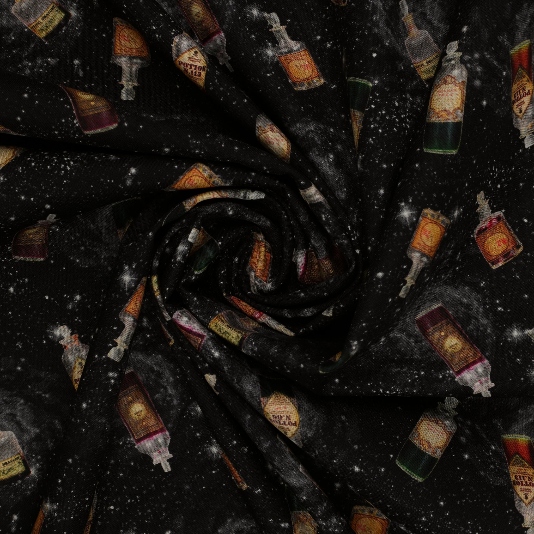 Black Harry Potter fabric with scattered potion bottles, antique-style labels, gray swirls and white stars in a swirl.