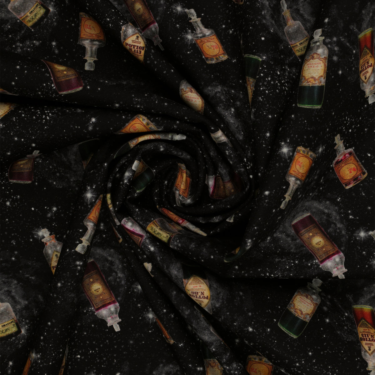 Black Harry Potter fabric with scattered potion bottles, antique-style labels, gray swirls and white stars in a swirl.