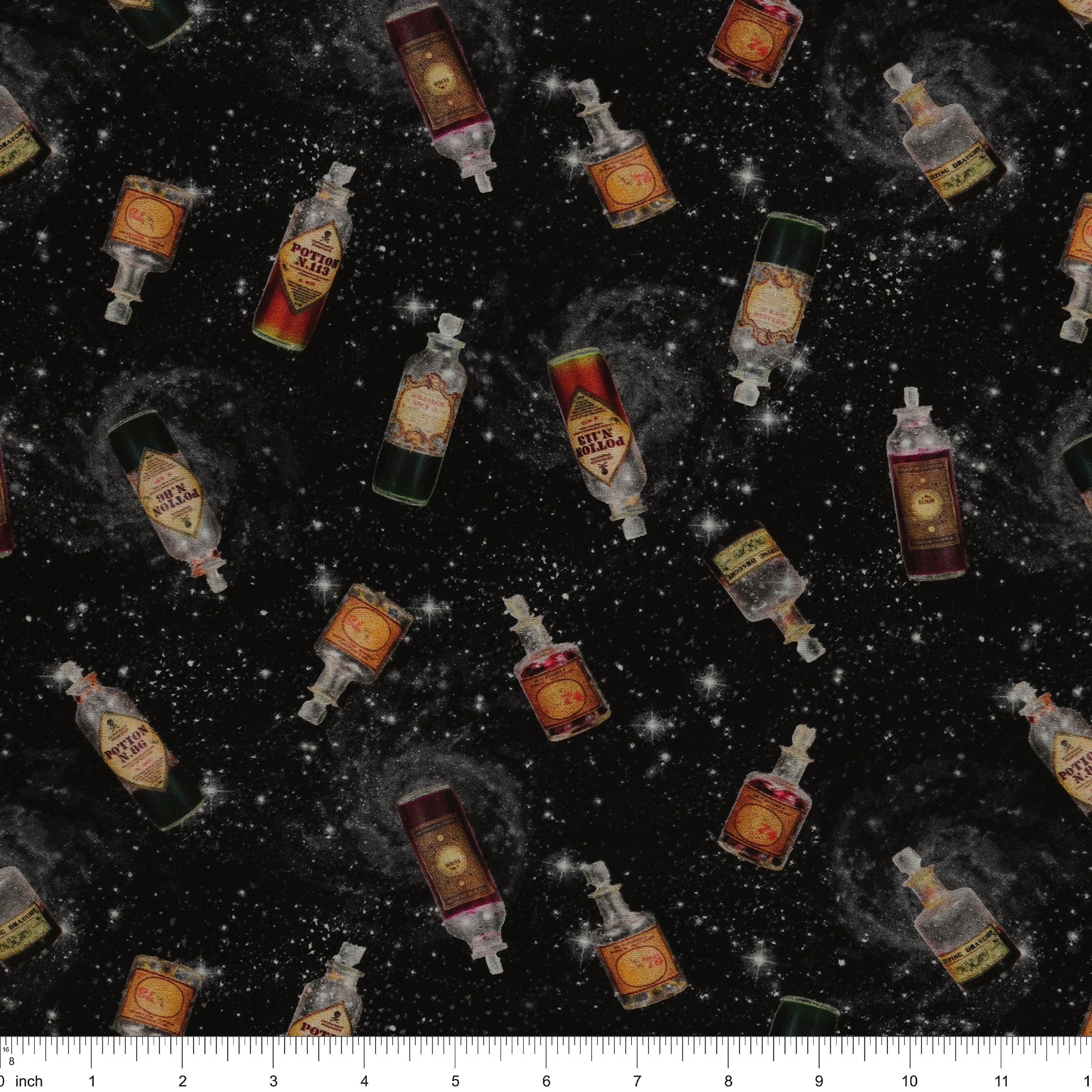Black Harry Potter fabric with scattered potion bottles, antique-style labels, gray swirls and white stars with ruler for scale.