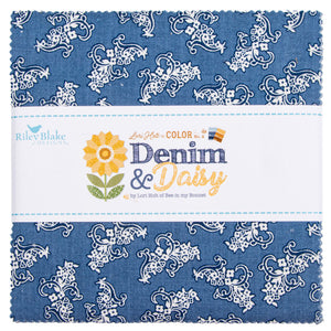 A folded fabric bundle with a blue and white floral paisley pattern, wrapped in a white paper band labeled Riley Blake Designs Denim & Daisy.