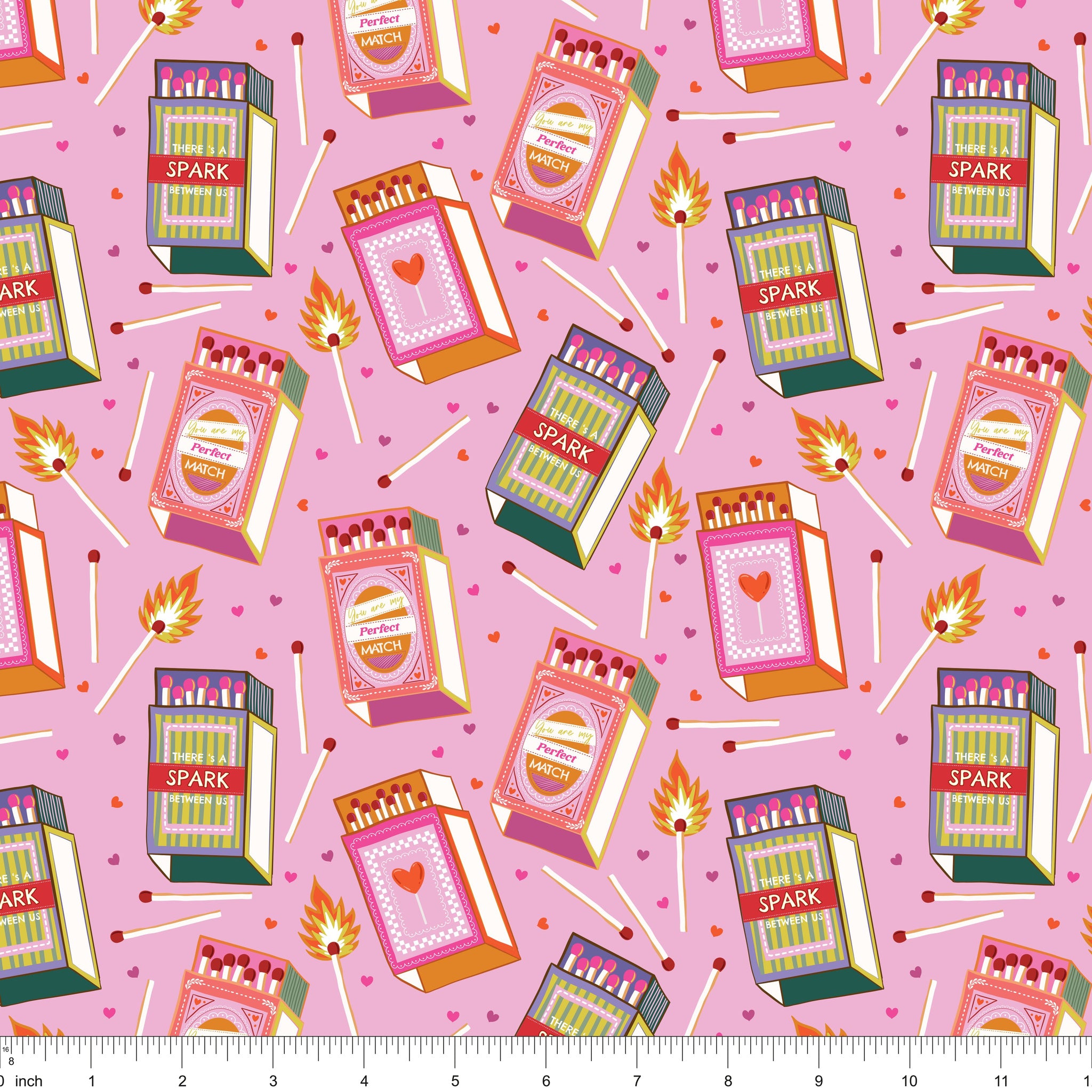 Pink fabric with retro matchboxes, lit matches and tiny hearts, shown with ruler for scale