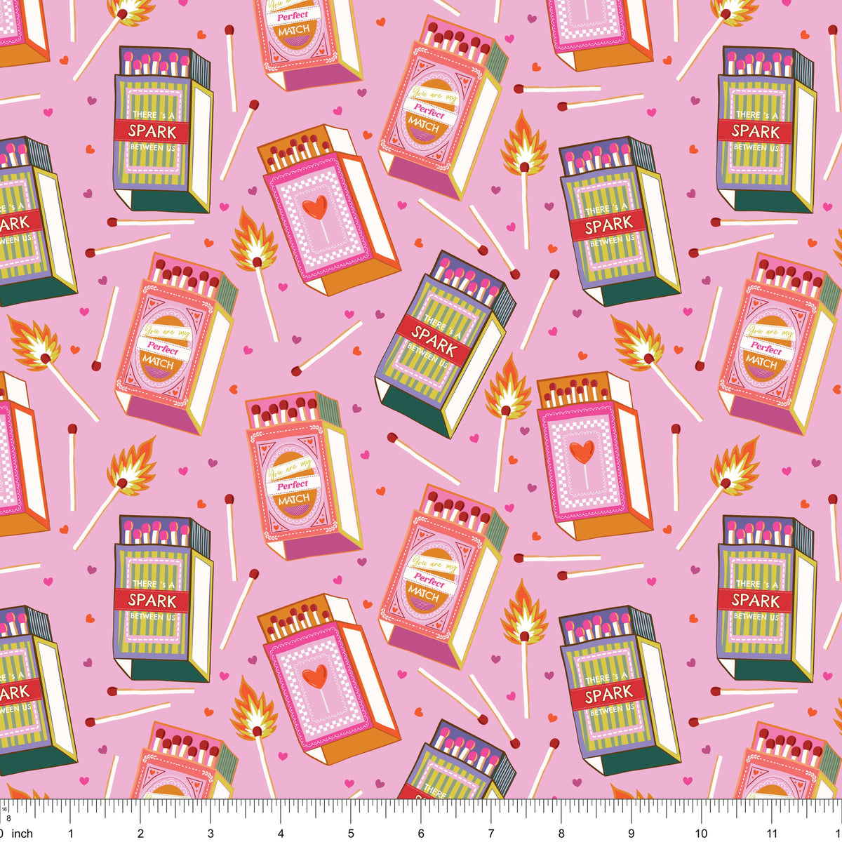 Pink fabric with retro matchboxes, lit matches and tiny hearts, shown with ruler for scale