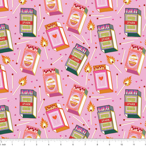 Pink fabric with retro matchboxes, lit matches and tiny hearts, shown with ruler for scale