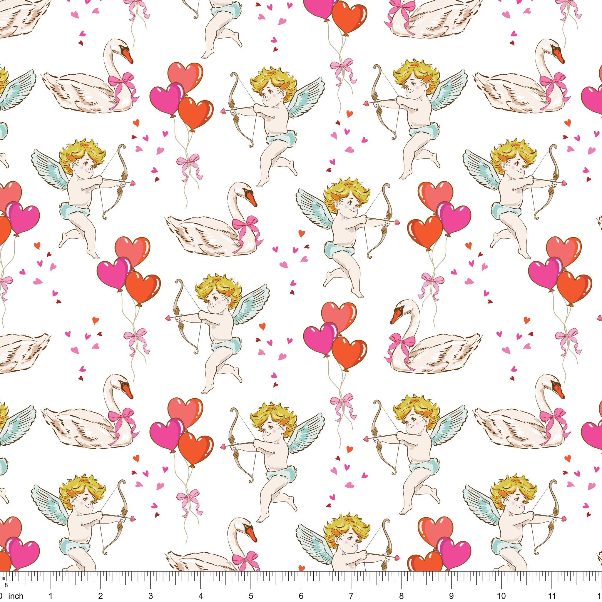 White fabric with cherubs drawing bows, swans and heart balloons, shown with ruler for scale