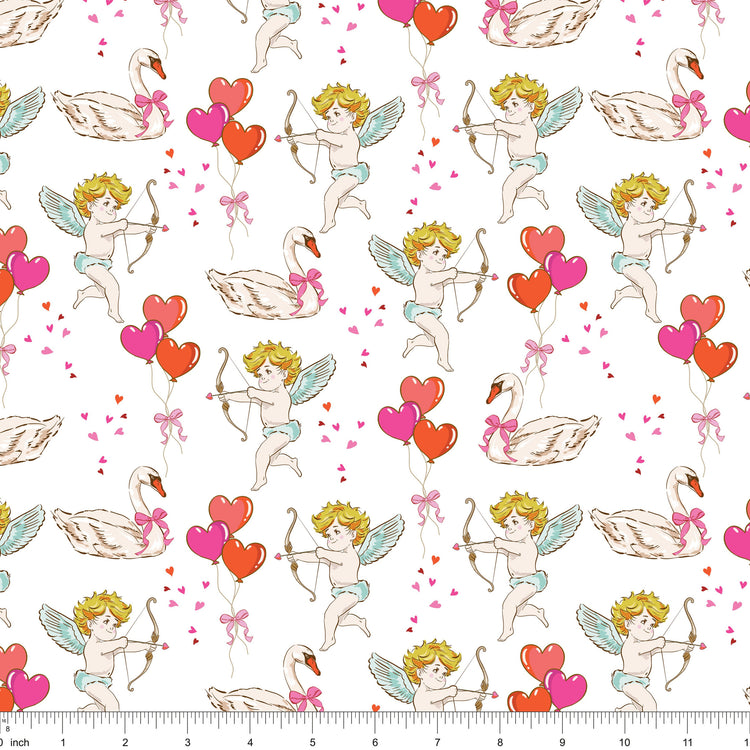 White fabric with cherubs drawing bows, swans and heart balloons, shown with ruler for scale