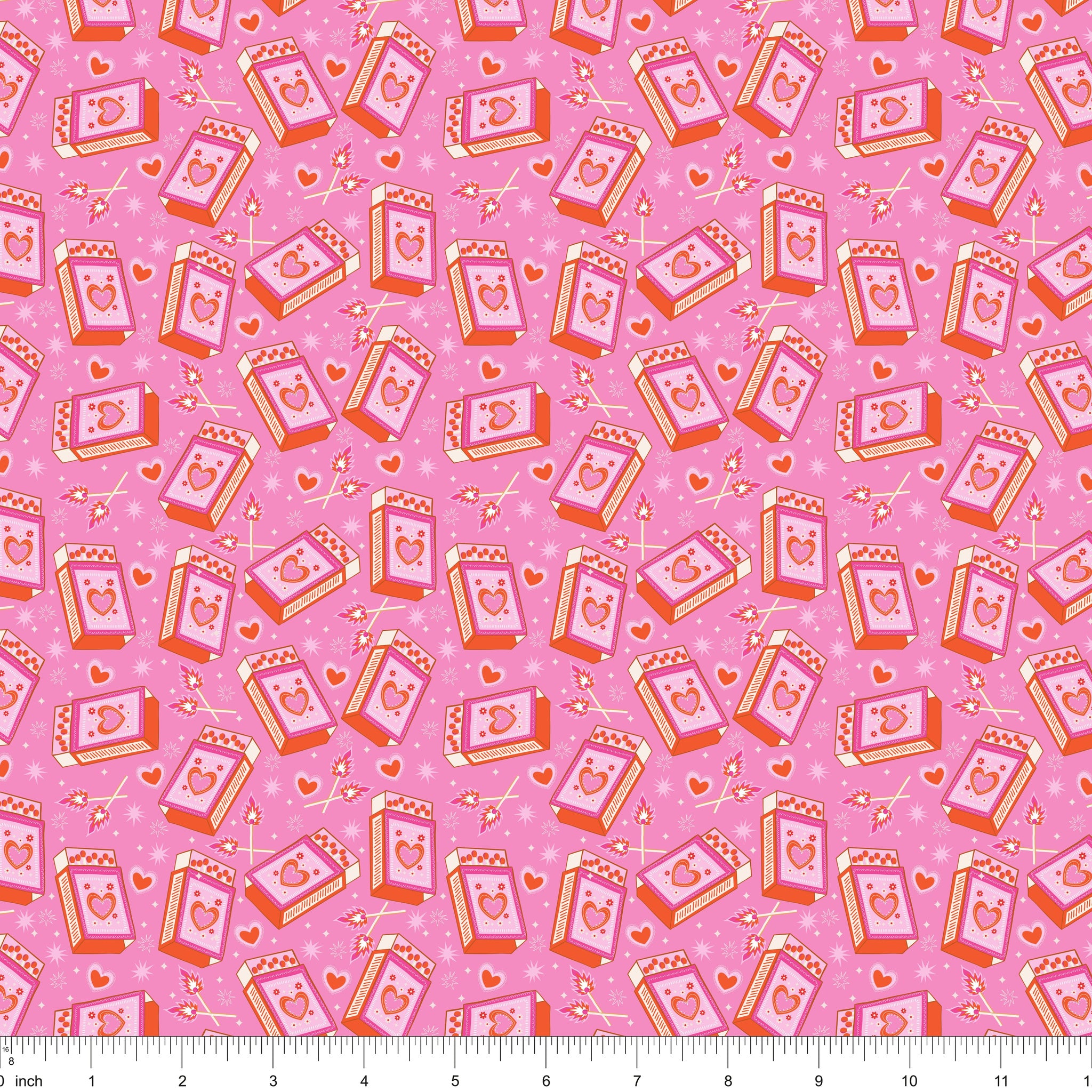 Pink fabric with tossed heart matchboxes and lit matches, shown with ruler for scale