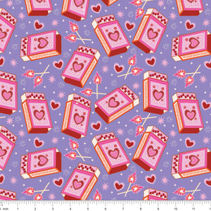 Lavender fabric with heart matchboxes, lit matches and sparkles, shown with ruler for scale