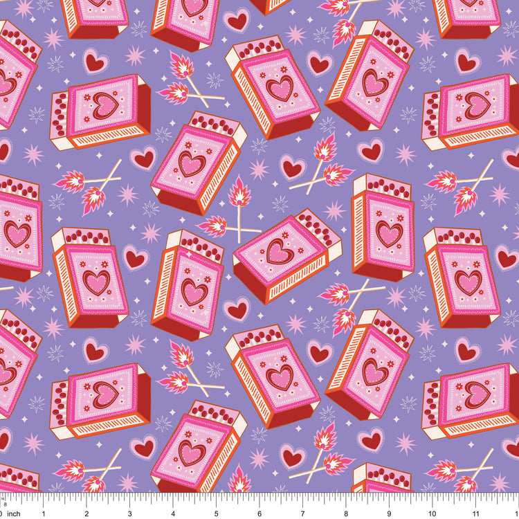 Lavender fabric with heart matchboxes, lit matches and sparkles, shown with ruler for scale