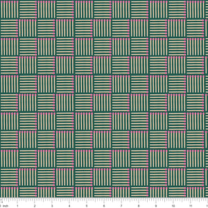 Dark green fabric with pink-tipped matchsticks in a basketweave, shown with ruler for scale