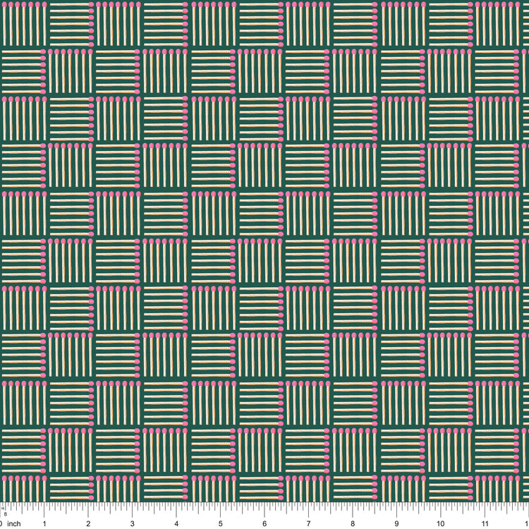 Dark green fabric with pink-tipped matchsticks in a basketweave, shown with ruler for scale