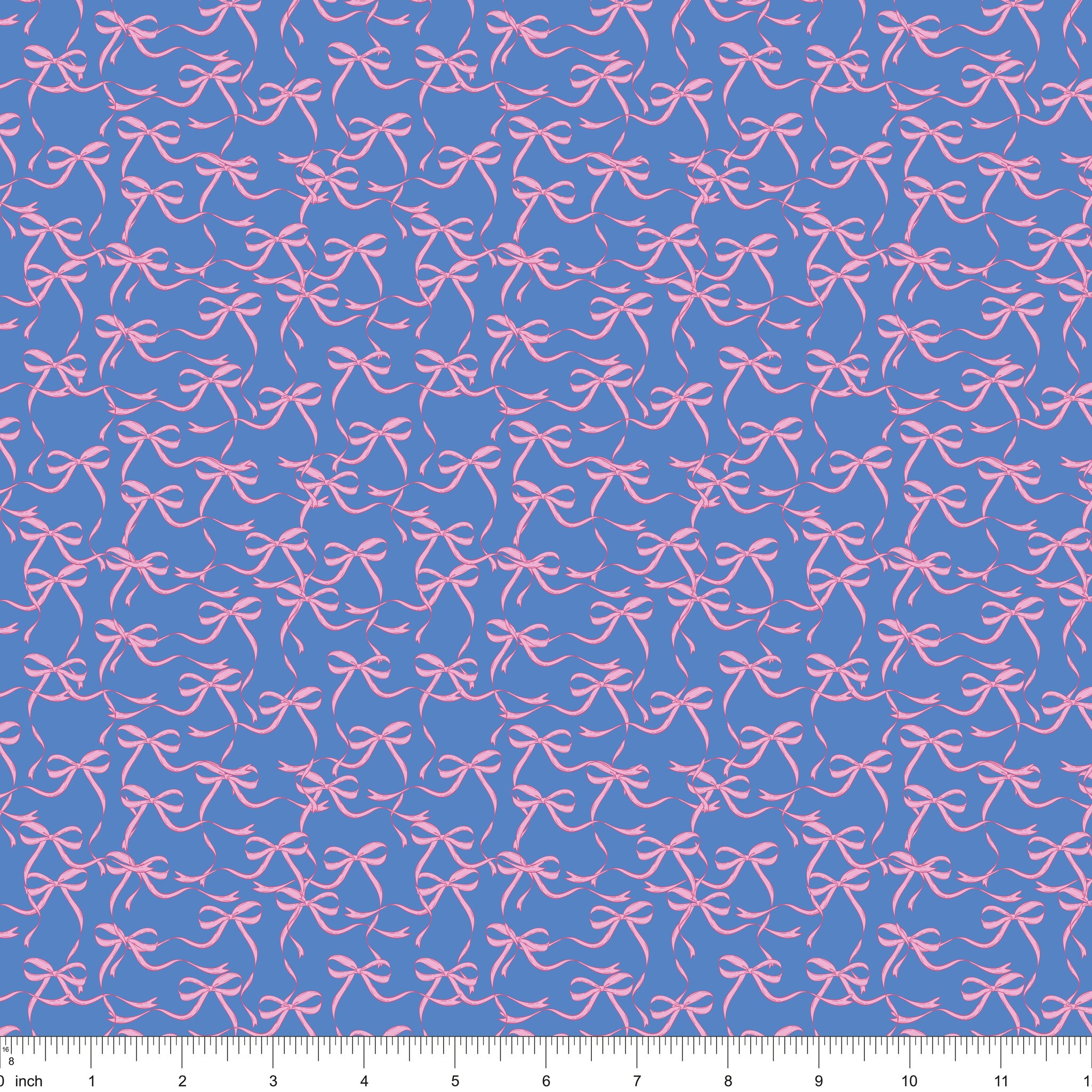 Blue fabric with flowing pink ribbon bows, shown with ruler for scale