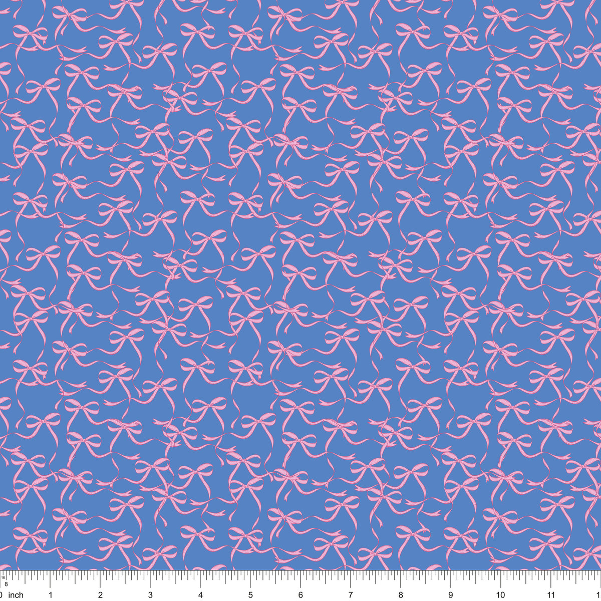Blue fabric with flowing pink ribbon bows, shown with ruler for scale