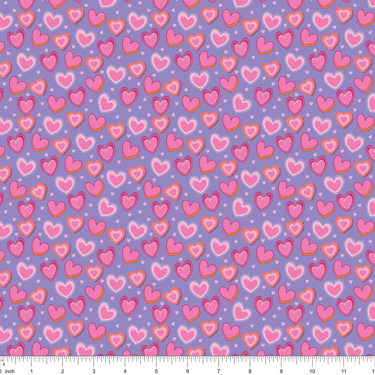 Lavender fabric with layered pink hearts, shown with ruler for scale