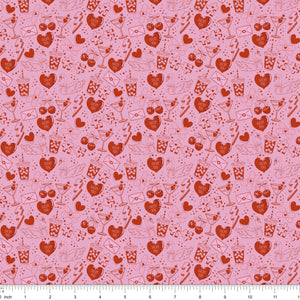 Pink fabric with red line drawings of hearts, swans, cocktails and Lucky You candy hearts, shown with ruler for scale