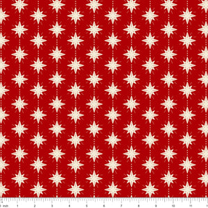 Cranberry red fabric with cream eight-point stars, shown with ruler for scale