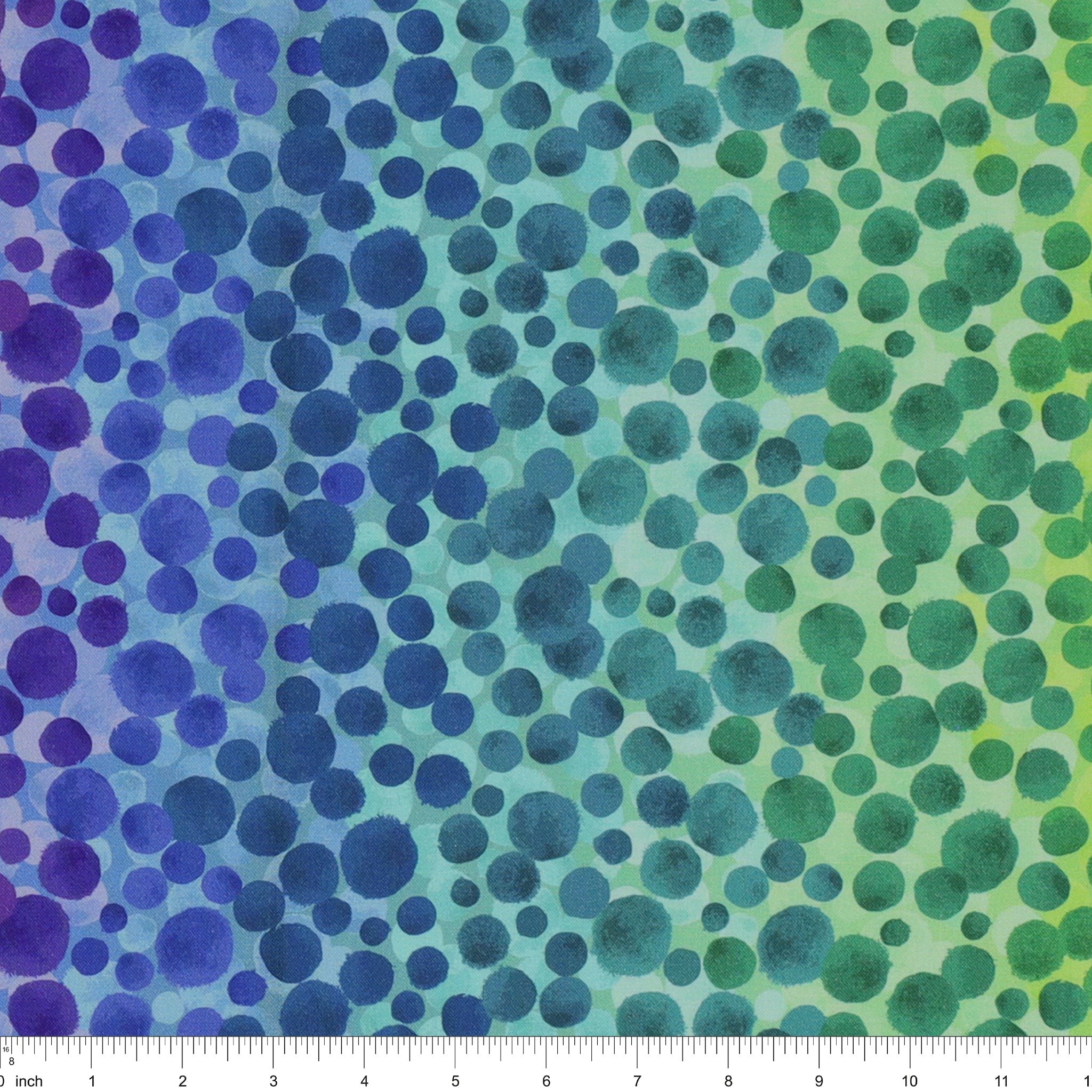 Bumbleberries Ocean fabric with irregular watercolor dots in shades of blue, turquoise, and sea green over a softly blended aqua-to-green background. Ruler for scale. 