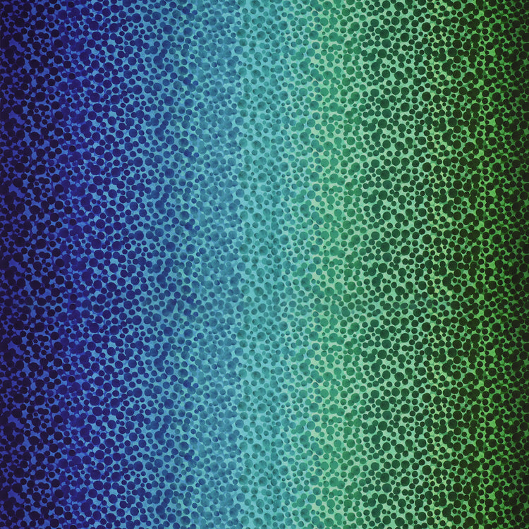 Bumbleberries Ocean fabric featuring densely scattered watercolor-style dots transitioning from deep navy and royal blue to turquoise, teal, and rich green.