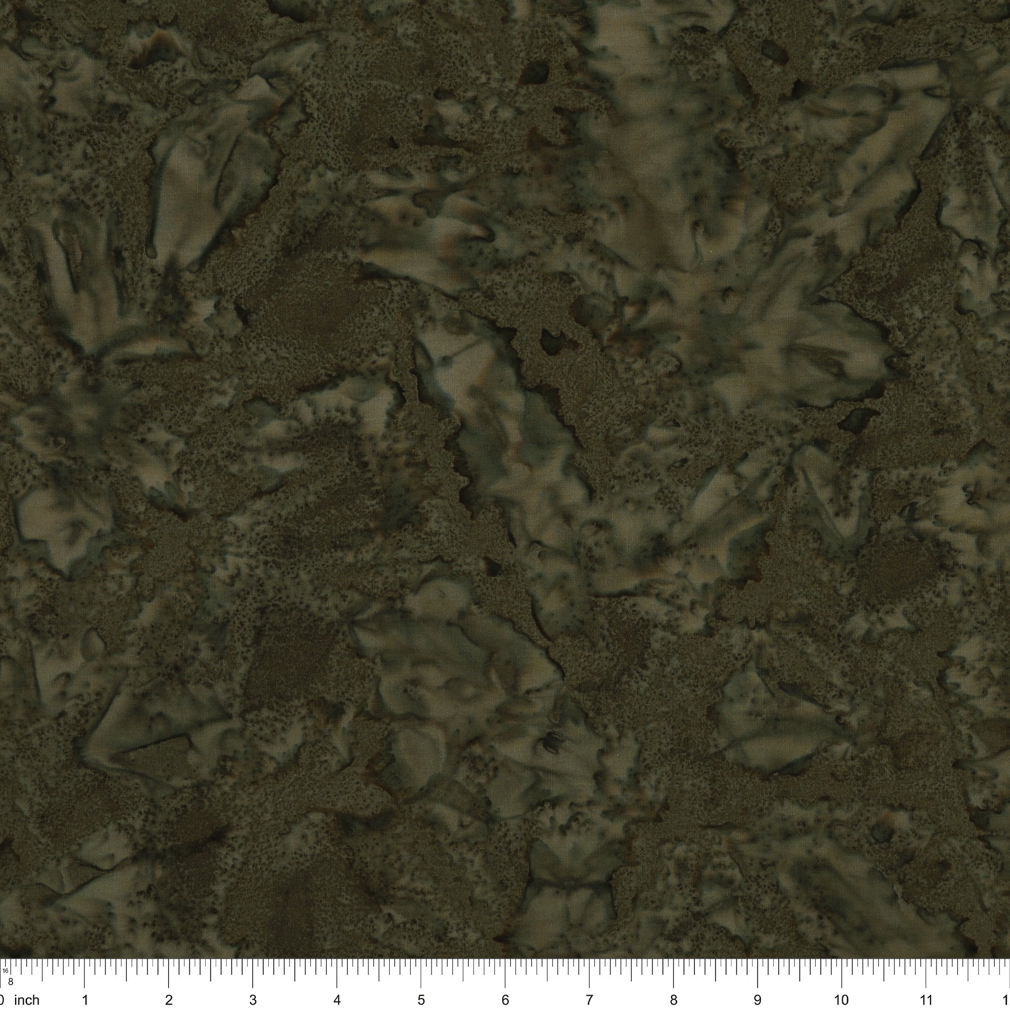 A close-up of a dark olive green and brown textured pattern with a ruler scale at the bottom indicating inches.
