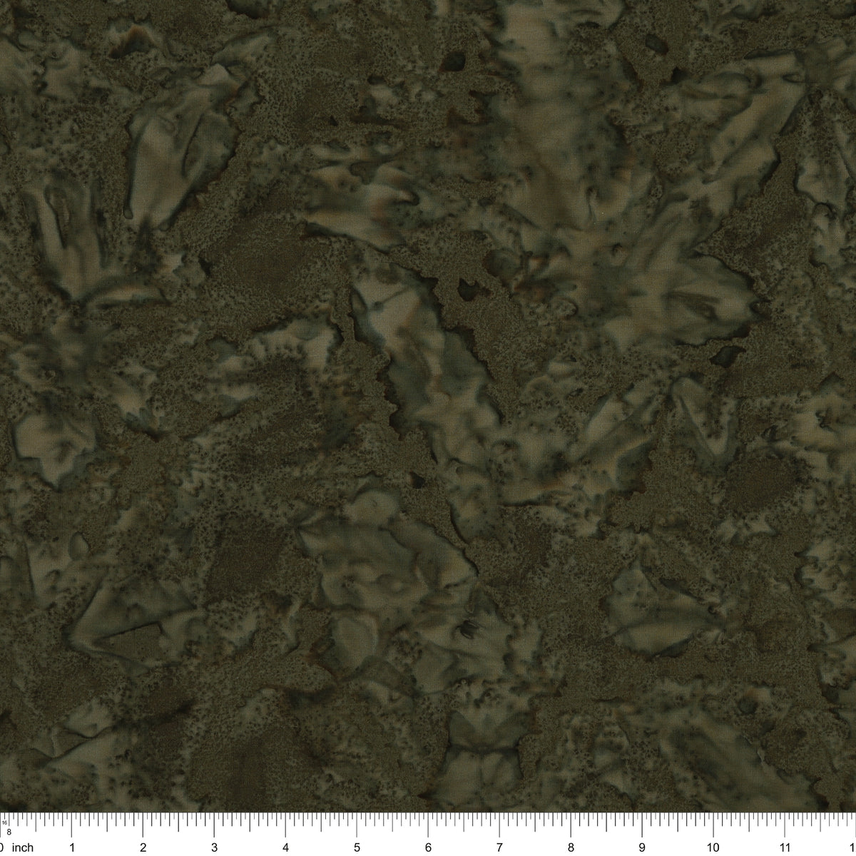 A close-up of a dark olive green and brown textured pattern with a ruler scale at the bottom indicating inches.