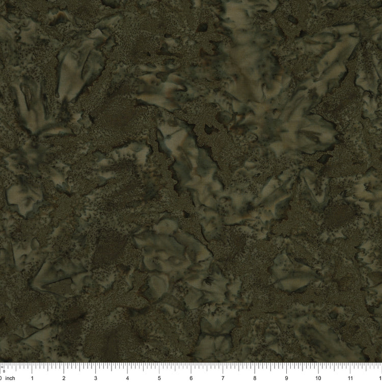 A close-up of a dark olive green and brown textured pattern with a ruler scale at the bottom indicating inches.