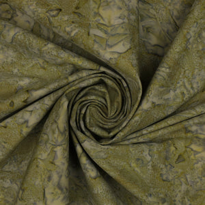 A close-up of patterned fabric arranged in a spiral drape, showing a mottled olive green, tan, and gray design.